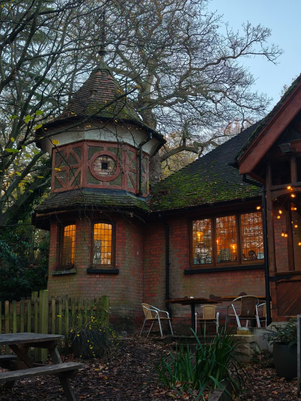 A small lodge-style cafe building lit up in the evening